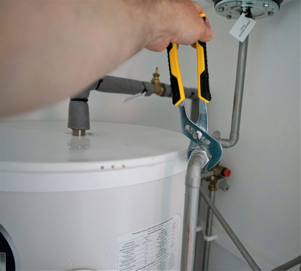 Wrench on a water heater supply line